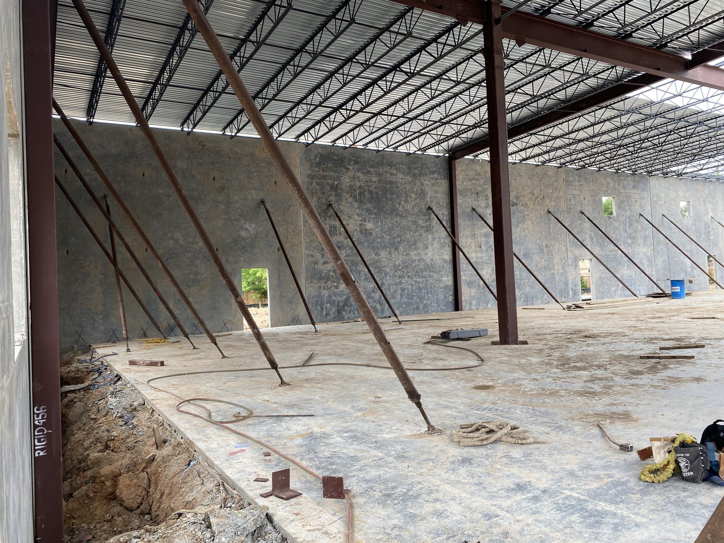 Interior of the shell with panel bracing, steel columns, and open-web roof joists