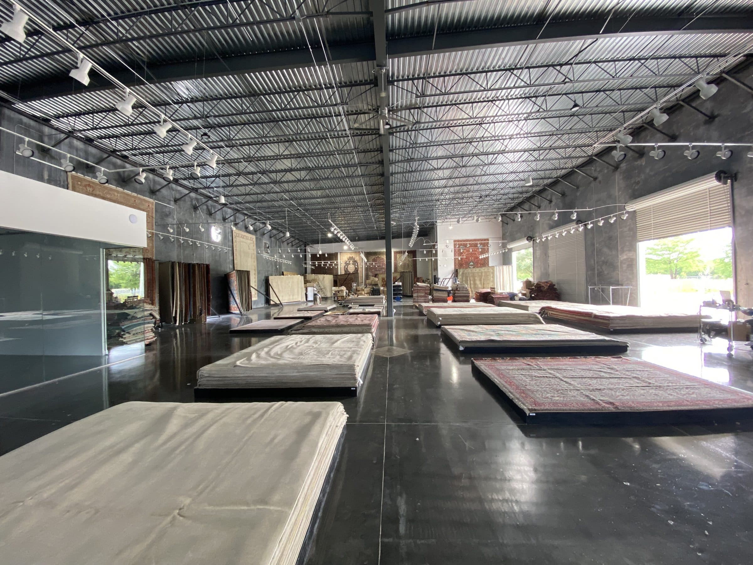 Finished showroom floor with rows of rugs on polished concrete