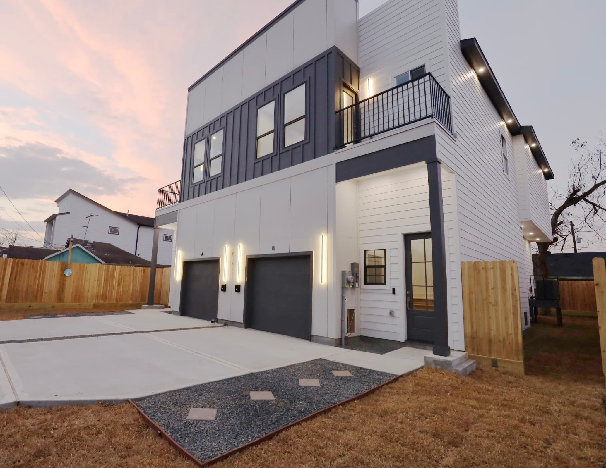 Duplex side view at twilight with LED accents and warm interior glow