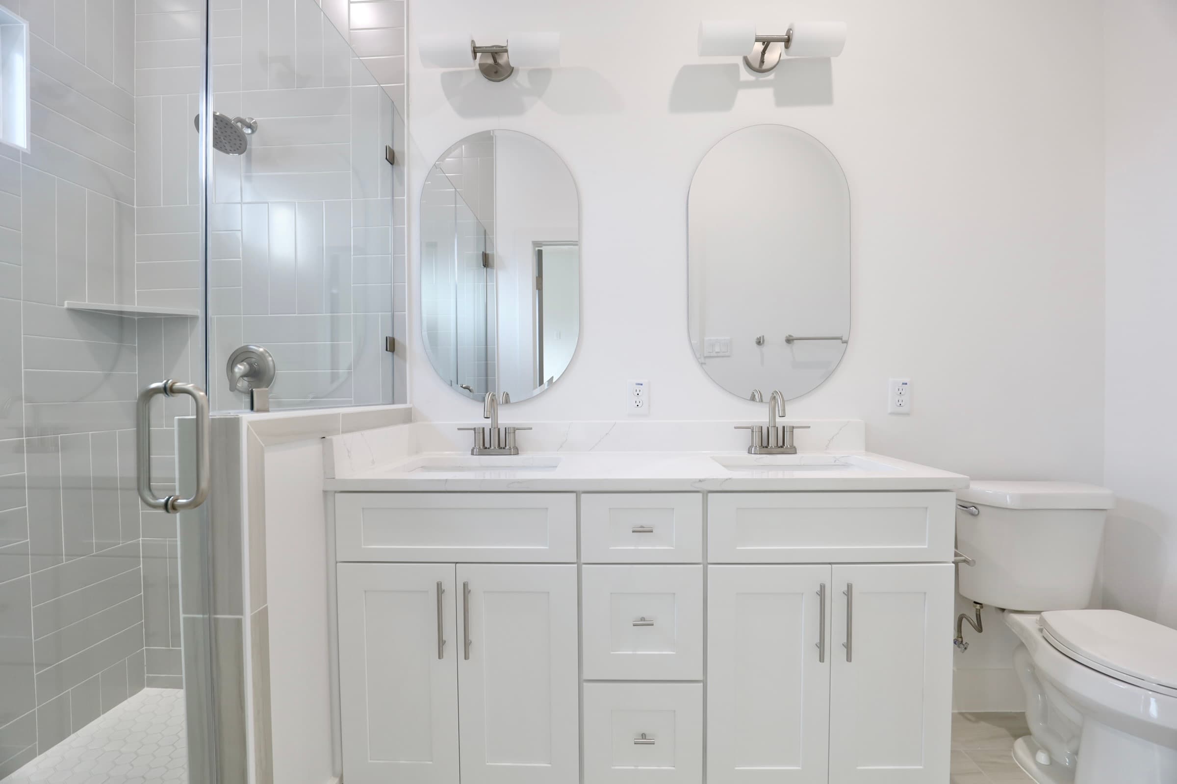 Master bathroom with double vanity and white subway tile